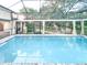 Enclosed pool with lush landscaping, creating a serene backyard oasis at 6801 S Sparkman St, Tampa, FL 33616