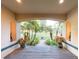 Covered porch with views of the lush landscaping and a charming architectural niche at 6801 S Sparkman St, Tampa, FL 33616