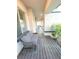 Cozy covered porch featuring a comfortable wicker chair and a view of the serene outdoors at 6801 S Sparkman St, Tampa, FL 33616