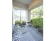 Cozy outdoor porch featuring comfortable seating, greenery, and view of the surrounding landscaping at 6801 S Sparkman St, Tampa, FL 33616
