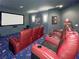 Home movie room with comfortable seating, a large screen, and cozy, dim lighting at 6801 S Sparkman St, Tampa, FL 33616