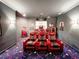 Home theater featuring plush red seating, a popcorn machine, and movie poster decorations at 6801 S Sparkman St, Tampa, FL 33616