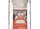Spacious walk-in closet with custom shelves, drawers, cherry wood floors and a decorative area rug at 6801 S Sparkman St, Tampa, FL 33616