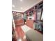 A walk-in closet features custom-built shelves, drawers, and ample storage with a decorative area rug at 6801 S Sparkman St, Tampa, FL 33616