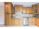 Kitchen showcasing ample wooden cabinetry, countertop space, and stainless steel dishwasher at 705 1St Ct, Palm Harbor, FL 34684