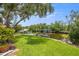 Lush backyard with manicured lawn and waterfront access, featuring a dock and boat lift, perfect for boating enthusiasts at 715 45Th Ne Ave, St Petersburg, FL 33703