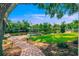 Backyard with lush lawn, brick path, landscaping, and waterfront views with multiple docks and boat lifts at 715 45Th Ne Ave, St Petersburg, FL 33703