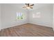 Bright bedroom with wood floors and two windows at 715 45Th Ne Ave, St Petersburg, FL 33703