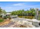 Waterfront boat dock with lift and seating area, providing convenient access to the water for boating and recreational activities at 715 45Th Ne Ave, St Petersburg, FL 33703