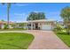 Charming single-story home featuring a brick driveway, manicured lawn, and attached garage at 715 45Th Ne Ave, St Petersburg, FL 33703