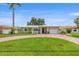 Charming home featuring a well-maintained lawn, brick driveway, and integrated garage, all under a clear blue sky at 715 45Th Ne Ave, St Petersburg, FL 33703