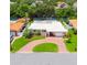 Charming home featuring a well manicured lawn, beautiful landscaping, and a brick circular driveway at 715 45Th Ne Ave, St Petersburg, FL 33703