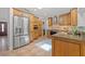 Gourmet kitchen with stainless steel appliances, a wine cooler, and custom wood cabinetry at 715 45Th Ne Ave, St Petersburg, FL 33703