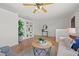 Well-lit living room featuring a built-in shelving unit, ceiling fan and open access to the front door at 715 45Th Ne Ave, St Petersburg, FL 33703