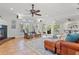 Cozy living room featuring tile floors, fireplace, ceiling fan, and sliding doors leading to the outdoor area at 715 45Th Ne Ave, St Petersburg, FL 33703