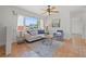 Bright living room with a large window, ceiling fan, neutral paint, and comfortable seating at 715 45Th Ne Ave, St Petersburg, FL 33703