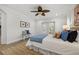 Bright main bedroom with a ceiling fan, wood floors, and access to a private outdoor space at 715 45Th Ne Ave, St Petersburg, FL 33703