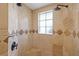 Shower features tiled walls, a shower head, and a window offering natural light at 715 45Th Ne Ave, St Petersburg, FL 33703