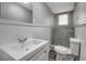 Well-lit bathroom with gray tile shower, wood look floors, contemporary sink vanity, and ample lighting at 7411 Seashore Dr, Port Richey, FL 34668