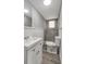 Beautiful bathroom featuring gray tile shower, wood look floors, contemporary sink vanity, and ample lighting at 7411 Seashore Dr, Port Richey, FL 34668
