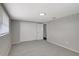 Relax in this comfortable bedroom, featuring a spacious closet, gray carpet, and fresh, neutral paint at 7411 Seashore Dr, Port Richey, FL 34668