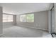 Carpeted bedroom with natural light entering from the large windows at 7411 Seashore Dr, Port Richey, FL 34668