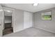 Spacious and well-lit bedroom features gray carpet, neutral paint, and ample closet space for optimal living at 7411 Seashore Dr, Port Richey, FL 34668