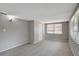 Cozy bedroom with neutral carpet, natural light, and closet at 7411 Seashore Dr, Port Richey, FL 34668
