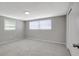 Neutral bedroom offers cozy gray carpet, a blank canvas for decorating, and plenty of natural light at 7411 Seashore Dr, Port Richey, FL 34668