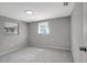 This bedroom boasts natural light, gray carpet, a large closet, and a neutral palette ready for customization at 7411 Seashore Dr, Port Richey, FL 34668