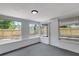 Bright sunroom with multiple windows providing natural light and views of the fenced backyard at 7411 Seashore Dr, Port Richey, FL 34668