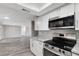View of updated kitchen features stainless steel appliances with open view to living space at 7411 Seashore Dr, Port Richey, FL 34668