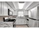 Contemporary kitchen features granite counters, stainless steel appliances, and ample natural light at 7411 Seashore Dr, Port Richey, FL 34668