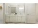 Bathroom featuring double sinks, a vanity with ample storage, and a separate shower for convenience and style at 7528 E 116Th St, Palmetto, FL 34221