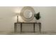 Stylish console table with mirror and modern decor, adding elegance to the hallway at 7542 E 117Th Ln, Palmetto, FL 34221
