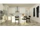 Bright kitchen features stainless steel appliances, center island with seating, and wood-look floors at 7542 E 117Th Ln, Palmetto, FL 34221