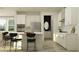 Modern kitchen with white cabinets, stainless steel appliances, stone countertops and center island with seating at 7542 E 117Th Ln, Palmetto, FL 34221