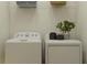 Convenient laundry area with washer, dryer, storage shelves and a house plant on top of the dryer at 7542 E 117Th Ln, Palmetto, FL 34221