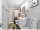 Elegant bathroom with a gray color scheme, wood-look floors, and a stylish white vanity with a large mirror at 7741 Forest Trl # 6, Port Richey, FL 34668