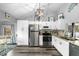 Bright kitchen featuring sleek white cabinetry, stainless steel appliances, and modern decor at 7741 Forest Trl # 6, Port Richey, FL 34668