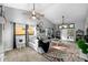 Bright, expansive living room featuring high ceilings, large windows, and stylish decor at 7741 Forest Trl # 6, Port Richey, FL 34668