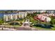Aerial view of condo buildings with manicured grounds, ponds, and waterfront access at 7932 Sailboat Key S Blvd # 506, South Pasadena, FL 33707