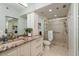 Clean bathroom with updated vanity, granite counters, and tiled walk-in shower at 7932 Sailboat Key S Blvd # 506, South Pasadena, FL 33707