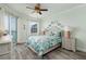 Comfortable bedroom featuring a ceiling fan, water view, and coastal furnishings at 7932 Sailboat Key S Blvd # 506, South Pasadena, FL 33707