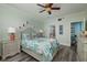 Relaxing bedroom boasting ceiling fan, coastal accents, and ensuite bathroom access at 7932 Sailboat Key S Blvd # 506, South Pasadena, FL 33707