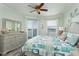 Airy bedroom features a ceiling fan, water view, and stylish coastal decor at 7932 Sailboat Key S Blvd # 506, South Pasadena, FL 33707
