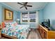 Comfortable bedroom with ceiling fan, coastal artwork, and beautiful water views at 7932 Sailboat Key S Blvd # 506, South Pasadena, FL 33707