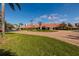 Beautiful clubhouse entrance with tropical landscaping and an American flag displayed at 7932 Sailboat Key S Blvd # 506, South Pasadena, FL 33707