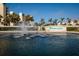 Harbour Side sign beside a pond with a fountain, framed by palm trees and community buildings at 7932 Sailboat Key S Blvd # 506, South Pasadena, FL 33707