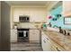 Kitchen with stainless steel appliances, granite countertops, and ample cabinetry at 7932 Sailboat Key S Blvd # 506, South Pasadena, FL 33707